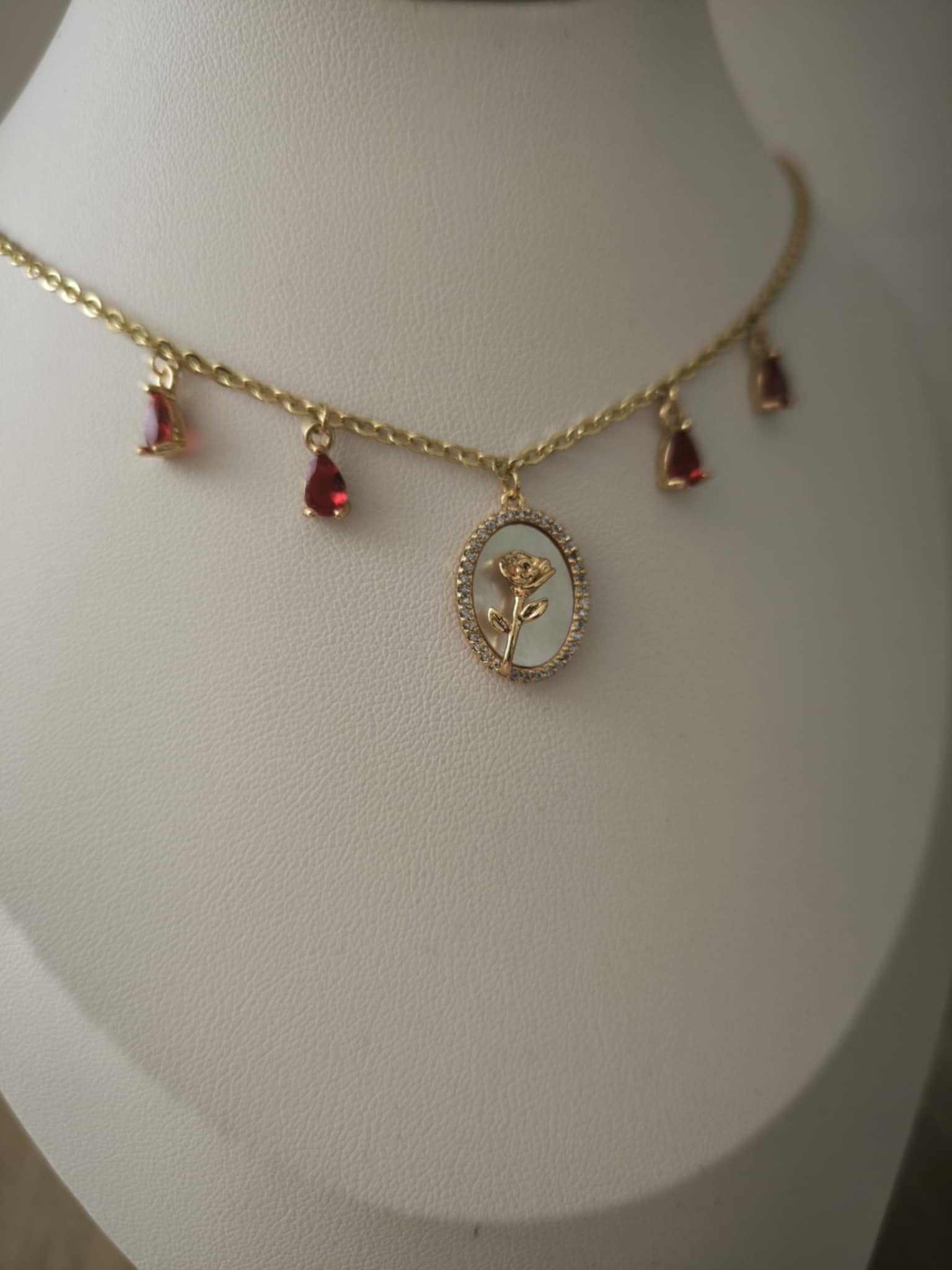 Découvrez le collier Rose Éternelle, collier rouge avec rose doré et nacre. Bijou artisanal en laiton plaqué or 18K. Pièce unique fait main avec certificat d'authenticité