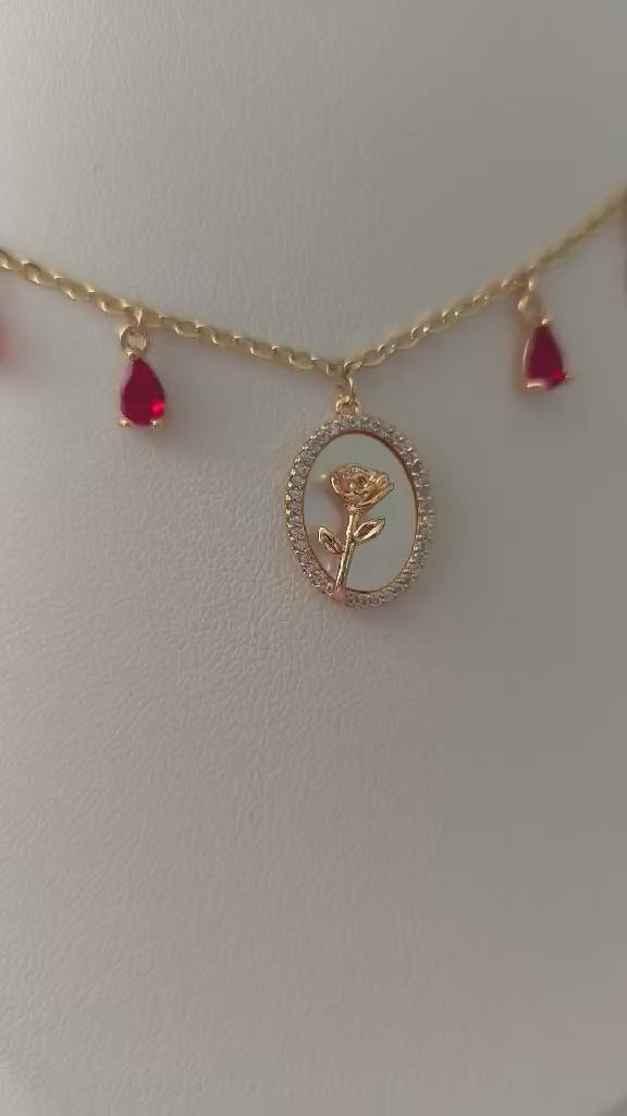 Découvrez le collier Rose Éternelle, collier rouge avec rose doré et nacre. Bijou artisanal en laiton plaqué or 18K. Pièce unique fait main avec certificat d'authenticité
